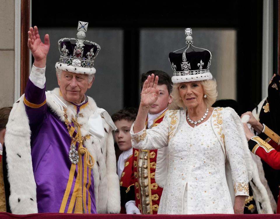 King Charles III and Queen Camilla wave from The Buckingham Palace balcony after the coronation on May 6.