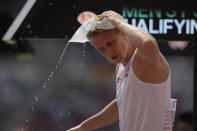 FILE - Robert Sobera, of Poland, cools off with an ice pack during the men's pole vault qualification at the World Athletics Championships in Budapest, Hungary, Wednesday, Aug. 23, 2023. (AP Photo/Ashley Landis, File)
