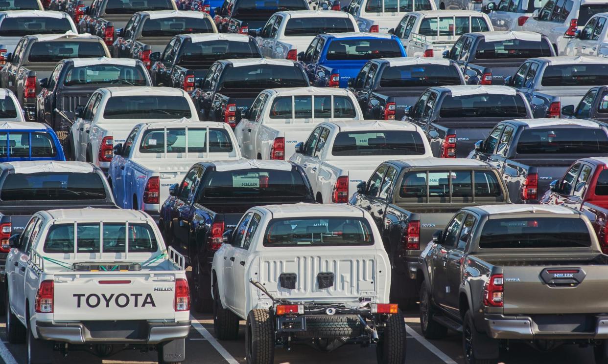 <span>Lines of new HiLux utes in a parking lot ahead of distribution. Toyota argues the government’s new emissions standard penalises rural and regional Australians.</span><span>Photograph: Bloomberg/Getty Images</span>