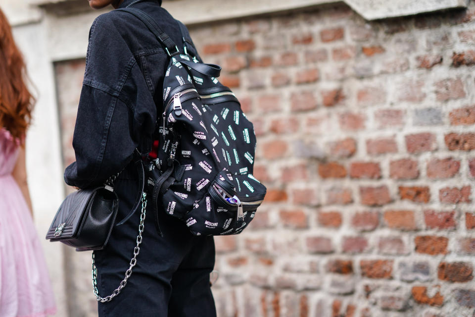 An attendee at Milan Fashion Week wearing a Moschino backpack and a Chanel purse on Sept. 20, 2019.&nbsp; (Photo: Edward Berthelot via Getty Images)