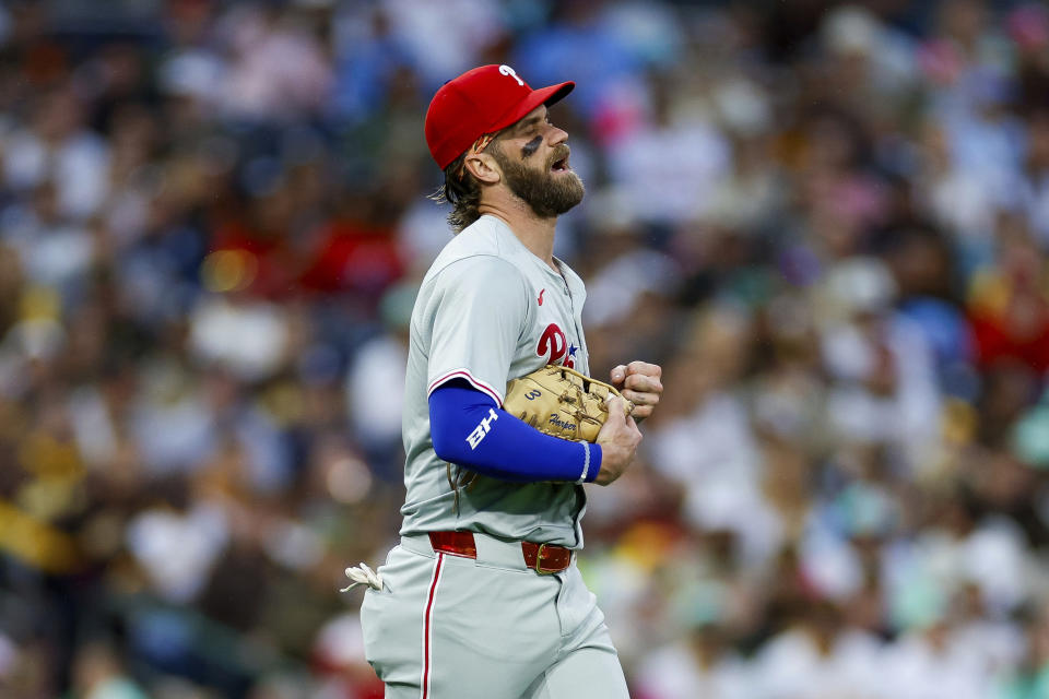 Philadelphia Phillies first basemen Bryce Harper reacts after a collision at first with San Diego Padres' Jurickson Profar during the second inning of a baseball game, Friday, April 26, 2024, in San Diego. (AP Photo/Brandon Sloter)