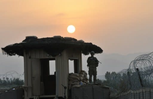 A US soldier stands on a watchtower in Khost province, eastern Afghanistan in 2011. A Taliban suicide bomber on a motorbike rammed an Afghan-NATO patrol in the town of Khost on Wednesday, killing 21 people, including three US soldiers, officials said