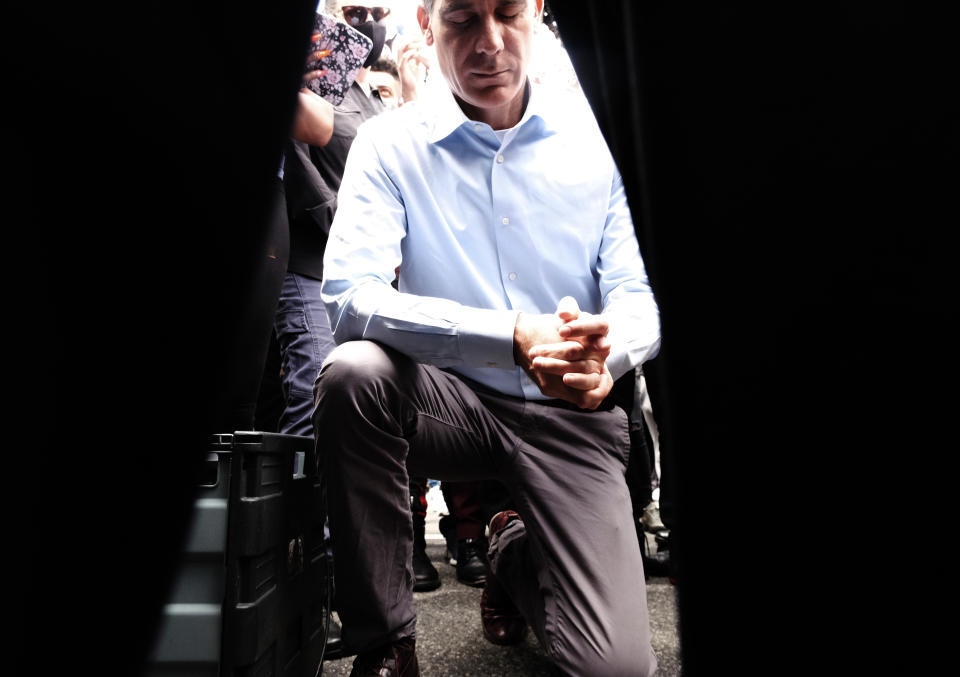 Joined by community faith leaders Los Angeles Mayor Eric Garcetti takes a knee in prayer during a Black Lives Matter protest in downtown Los Angeles on Tuesday, June 2, 2020. (AP Photo/Richard Vogel)