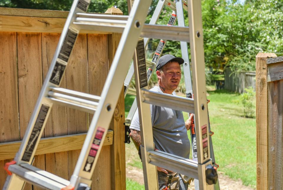 Zach Clanton, 33, does roofing work for Complete Exteriors in the heat in Brandon, Miss., Tuesday, June 21, 2022. When asked about working in the heat, he said, "you just get used to it."