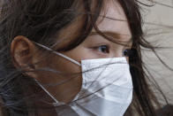 FILE - In this Wednesday, Aug. 5, 2020 file photo, activist Agnes Chow arrives at a court in Hong Kong. Police arrested prominent pro-democracy activist Agnes Chow Ting at her home, on charges of inciting secession under the national security law, according to tweets by fellow activist Nathan Law, who is currently in Britain. A post on Chow's official Facebook page said police had arrived at her home and that her lawyers were rushing to the scene. (AP Photo/Kin Cheung, File)