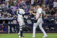 New York Yankees catcher Jose Trevino, left, and relief pitcher Jonathan Loaisiga celebrate their win after a baseball game against the New York Mets, Monday, Aug. 22, 2022, in New York. (AP Photo/Corey Sipkin)