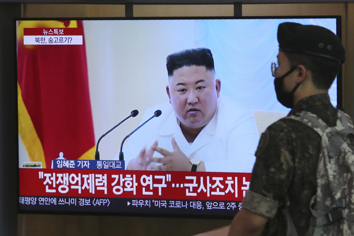 A South Korean army soldier passes by a TV showing a file image of North Korean leader Kim Jong Un during a news program at the Seoul Railway Station in Seoul, South Korea, Wednesday, June 24, 2020. Kim suspended his military's plans to take unspecified retaliatory action against South Korea, state media said Wednesday, possibly slowing a pressure campaign against its rival amid stalled nuclear negotiations with the Trump administration. The Korean letters read: "Strengthening deterrence of war." (AP Photo/Ahn Young-joon)