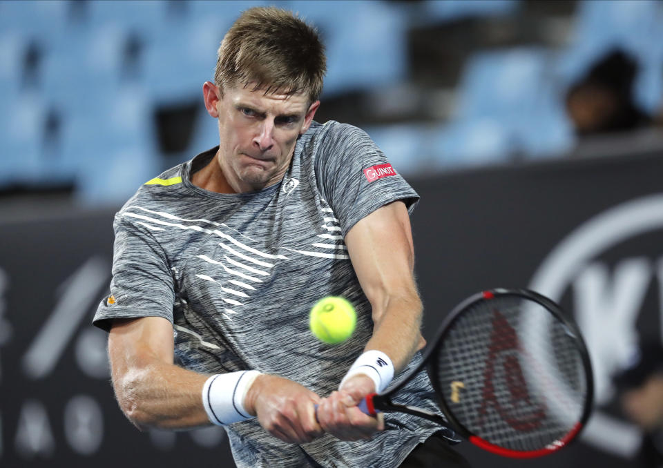 South Africa's Kevin Anderson makes a backhand return to Ilya Ivashka of Belarus during their first round singles match at the Australian Open tennis championship in Melbourne, Australia, Tuesday, Jan. 21, 2020. (AP Photo/Andy Wong)