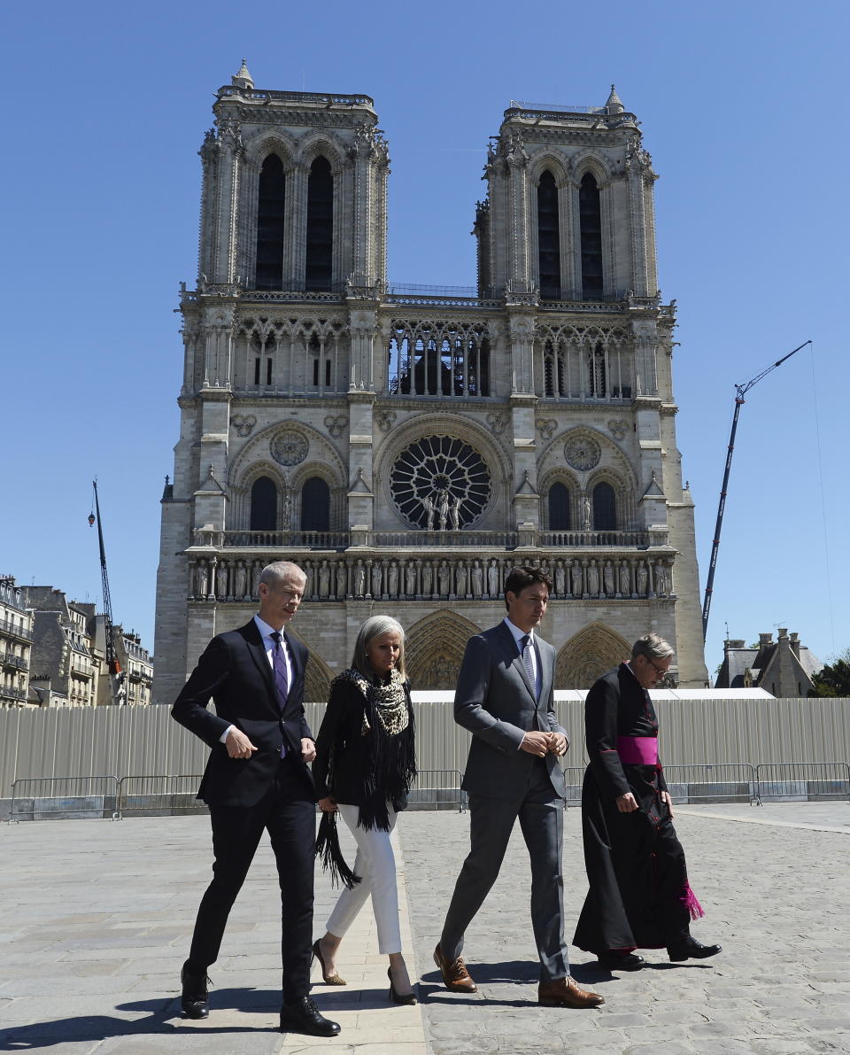 Canadian Prime Minister Justin Trudeau, second right, tours Notre Dame cathedral with Minister of Culture for France Franck Riester, left to right, Canadian Ambassador to France Isabelle Hudon and Monsignor Patrick Chauvet in Paris, France on Wednesday, May 15, 2019. (Adrian Wyld/The Canadian Press via AP)