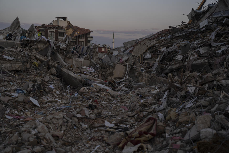 A minaret remained standing amidst the rubble of collapsed houses following an earthquake, in Antakya, Turkey, Saturday, Feb. 11, 2023. Rescue crews on Saturday pulled more survivors, including entire families, from toppled buildings despite diminishing hopes as the death toll of the enormous quake that struck a border region of Turkey and Syria five days continued to rise. (AP Photo/Petros Giannakouris)