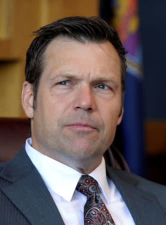 Kansas Secretary of State Kris Kobach looks on as he talks about the Kansas voter ID law that he pushed to combat what he believes to be rampant voter fraud in the United States in his Topeka, Kansas, U.S., office May 12, 2016. REUTERS/Dave Kaup