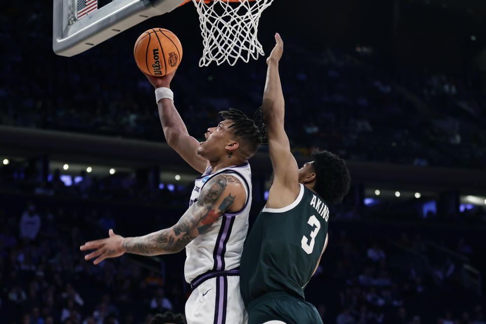 Kansas State forward Keyontae Johnson (11) attempts a layup as Michigan State guard Jaden Akins (3) defends in the first half of a Sweet 16 college basketball game in the East Regional of the NCAA tournament at Madison Square Garden, Thursday, March 23, 2023, in New York. (AP Photo/Adam Hunger)