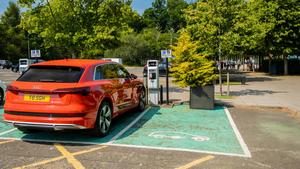 Loch Lomond, Scotland - July 25th 2021: Red Audi e-tron electric vehicle charging at a station in a car park