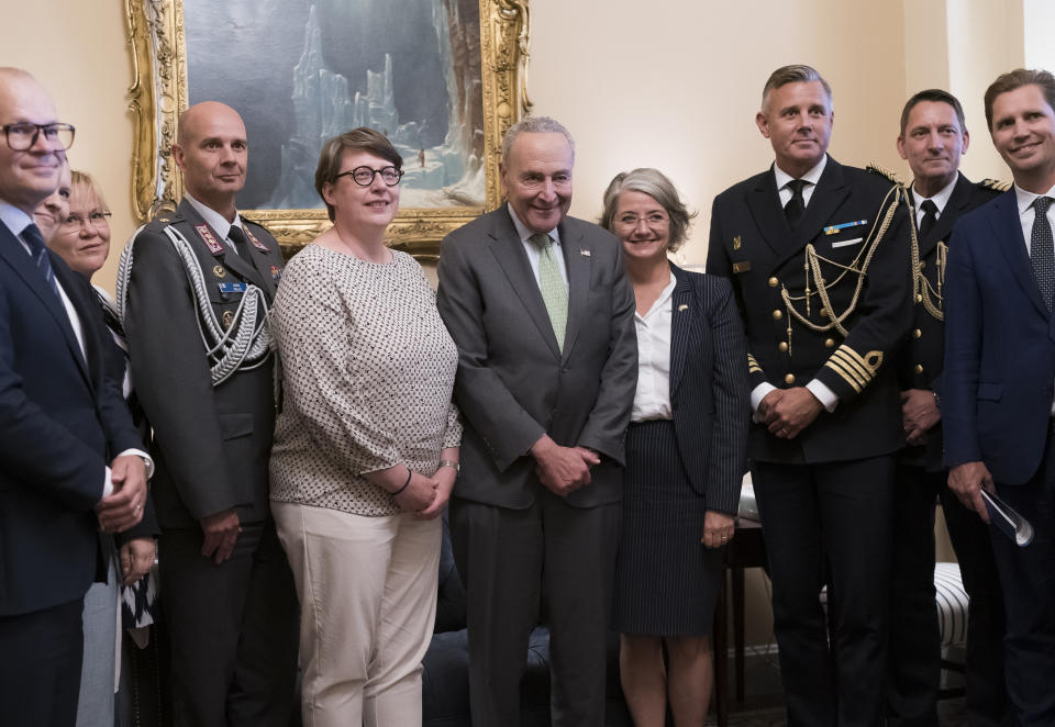 Senate Majority Leader Chuck Schumer, D-N.Y., center, is flanked by Paivi Nevala, minister counselor of the Finnish Embassy, left, and Karin Olofsdotter, Sweden's ambassador to the U.S., as he welcomes diplomats just before the Senate vote to ratify NATO membership for the two nations in response to Russia's invasion of Ukraine, at the Capitol in Washington, Wednesday, Aug. 3, 2022. (AP Photo/J. Scott Applewhite)