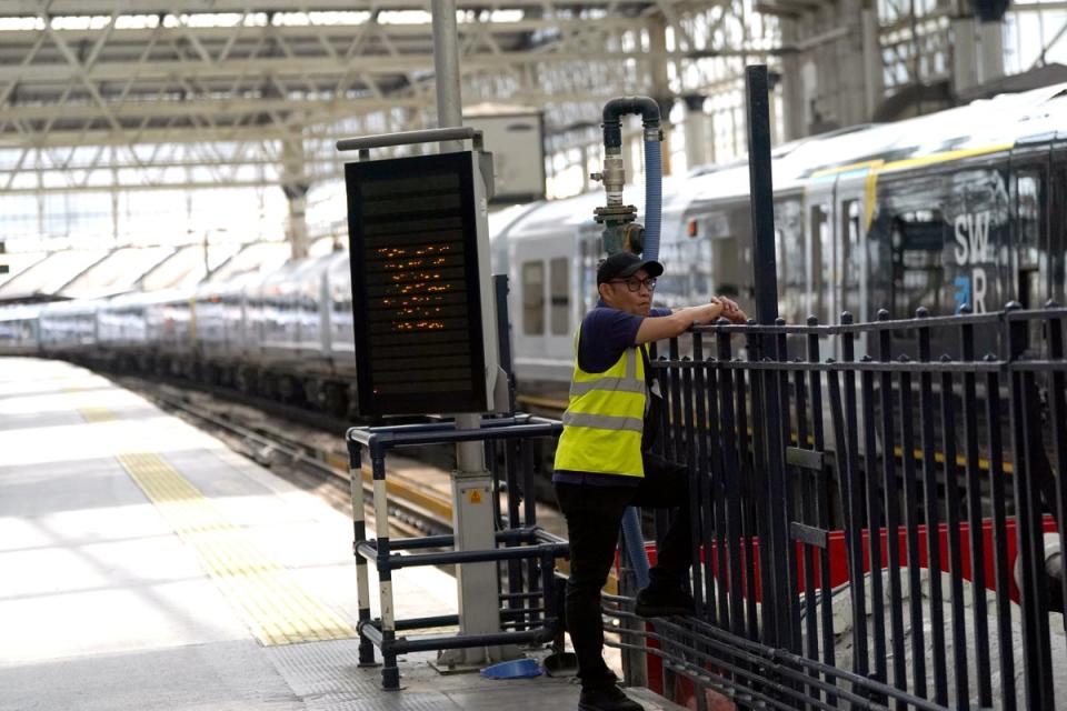 A member of staff on a empty platform platform at Waterloo Station (Victoria Jones/PA) (PA Wire)