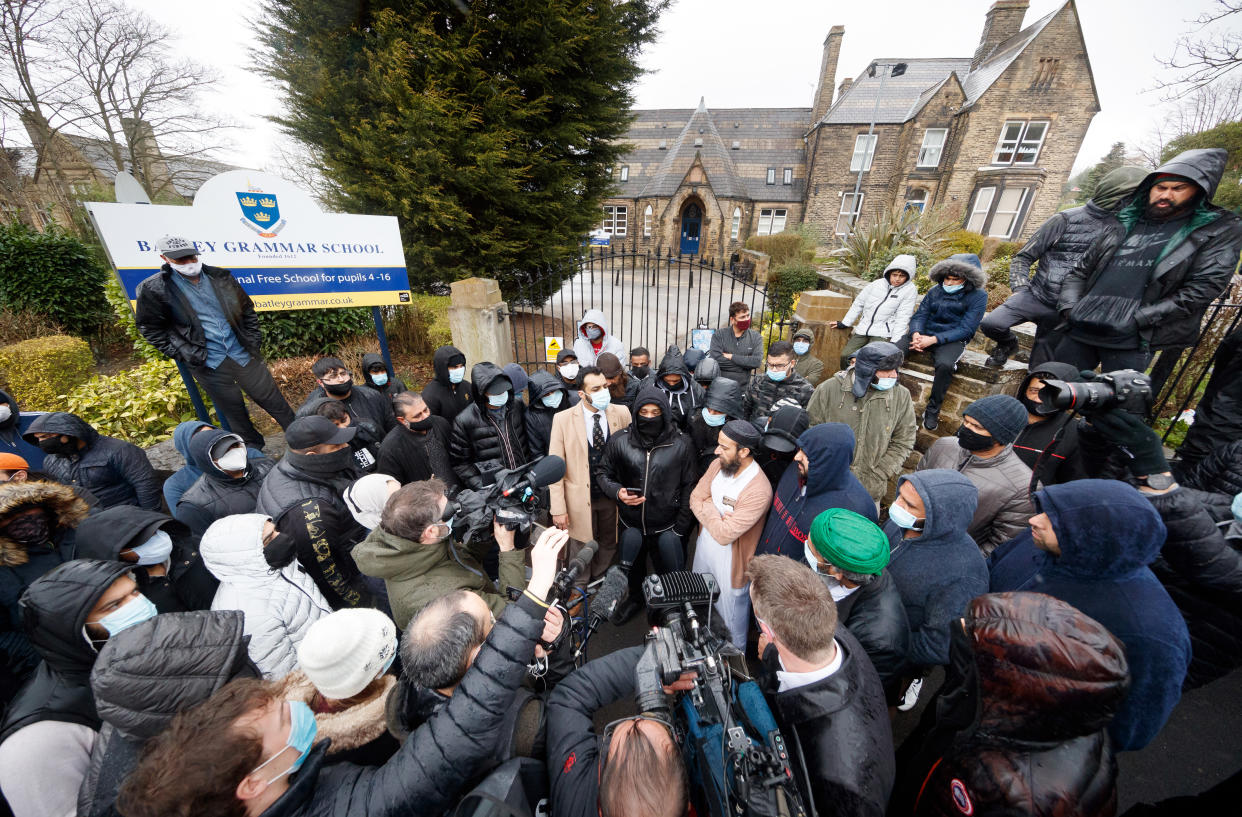 Protesters give a statement to members of the media outside Batley Grammar School in Batley, West Yorkshire, where a teacher has been suspended for reportedly showing a caricature of the Prophet Mohammed to pupils during a religious studies lesson. Picture date: Friday March 26, 2021.