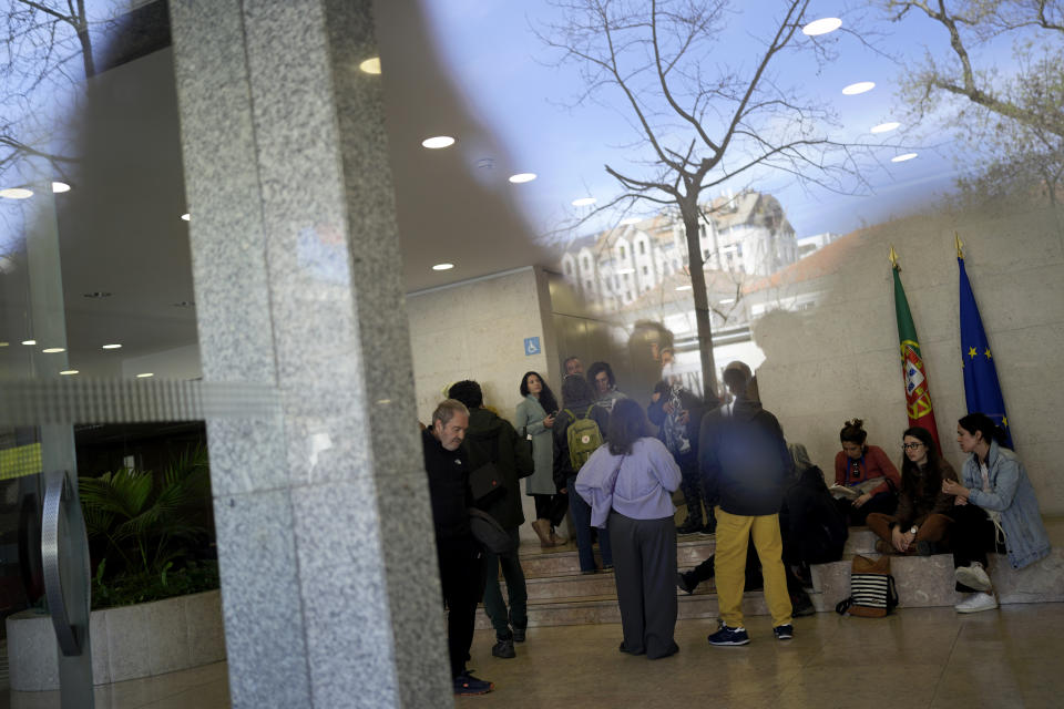 Activists and members of evicted families occupy the entrance hall of the Housing Ministry demanding a meeting with the minister to discuss the problem of forced evictions, in Lisbon, Monday, March 13, 2023. Portugal's center-left Socialist government last month unveiled a package of measures to address the housing problem, and some of them are set to be approved Thursday. (AP Photo/Armando Franca)