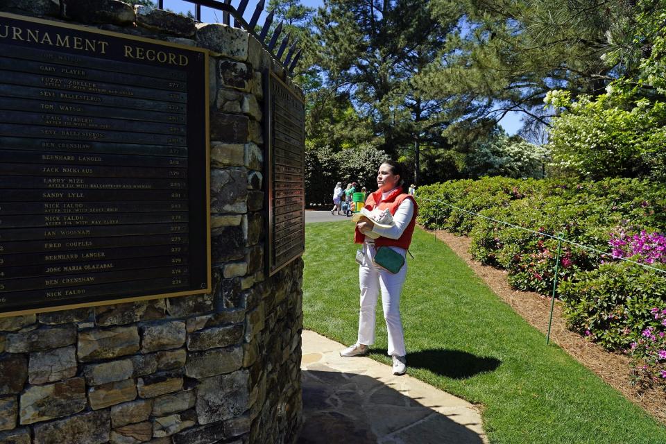 Sarah Layfield reads one of the plaques on the Record Fountain, which was moved from the No. 17 tee to the practice range at Augusta National Golf Club ahead of the 2024 Masters Tournament. It previously was a water fountain but is now a water-bottle filling station.