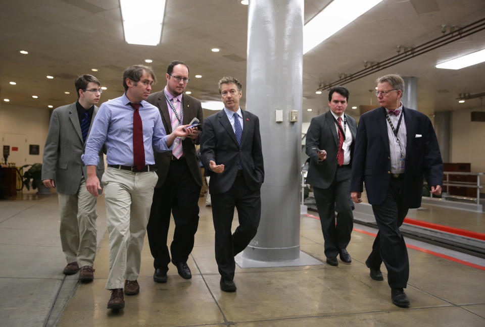 WASHINGTON, DC - DECEMBER 17:  U.S. Sen. Rand Paul (R-KY) (3rd R) talks to reporters after a vote December 17, 2013 on Capitol Hill in Washington, DC. The Senate has passed a cloture vote to clear the way for a final vote of the Ryan-Murray Bipartisan Budget Act of 2013.  (Photo by Alex Wong/Getty Images)