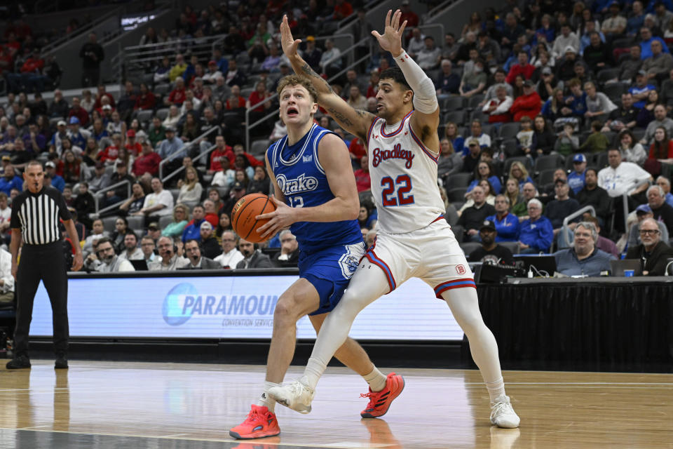 Drake guard Tucker DeVries, front left, looks to shoot as Bradley forward Ja'Shon Henry (22) defends during the first half of the championship game in the Missouri Valley Conference NCAA basketball tournament Sunday, March 5, 2023, in St. Louis. (AP Photo/Joe Puetz)