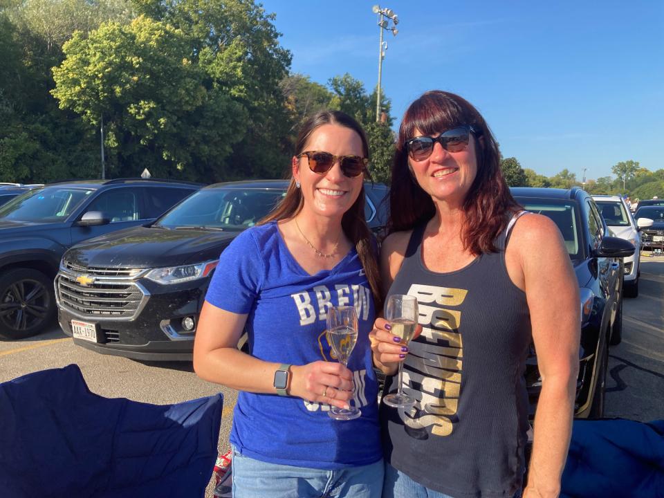 Amanda Uher, left, and her aunt, Lisa Kutil, have been going to Milwaukee Brewers games for years together. They swapped beer for champagne ahead of the team's playoff opener Tuesday against the Arizona Diamondbacks.