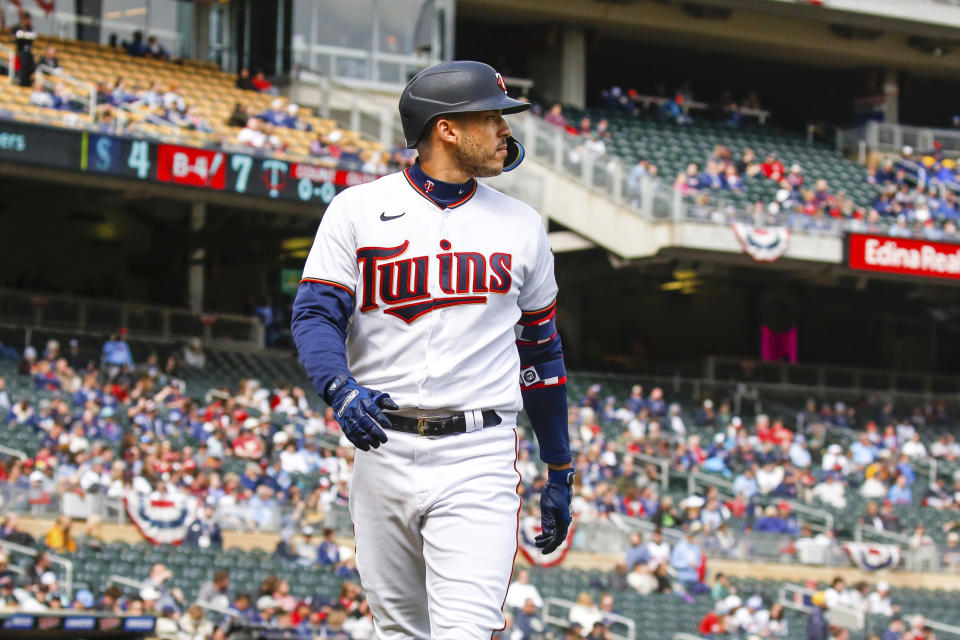 Minnesota Twins' Carlos Correa (4) returns to the dugout after lining out against the Seattle Mariners during the fourth inning of a baseball game Sunday, April 10, 2022, in Minneapolis. (AP Photo/Nicole Neri)
