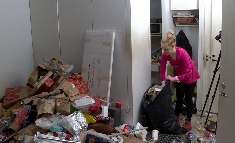 This video grab taken on January 19, 2023 shows Finnish TikTok cleanfluencer Auri Kananen tidying up a pile of trash and food remains in a flat in Helsinki, Finland. - Marie Kondo may have admitted defeat, but a new generation of "cleanfluencers" is taking social media by storm, with millions eager to watch them scour filthy homes and dole out hacks.