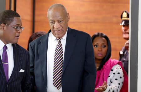 Actor and comedian Bill Cosby is helped through the metal detector as he arrives for the first day of his sexual assault trial at the Montgomery County Courthouse in Norristown, Pennsylvania, U.S. June 5, 2017. REUTERS/David Maialetti/Pool