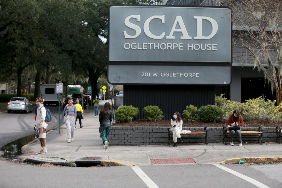 Savannah College of Art and Design students wait for a outside Oglethorpe House.