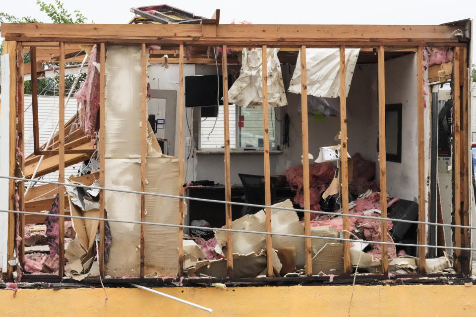 The wall of a tire shop at the intersection of Sowden and Bingle is blown out in the aftermath of a severe storm on Friday, May 17, 2024, in Houston. The widespread destruction brought much of Houston to a standstill as crews raced to restore power and remove uprooted trees and debris. (Brett Coomer/Houston Chronicle via AP)