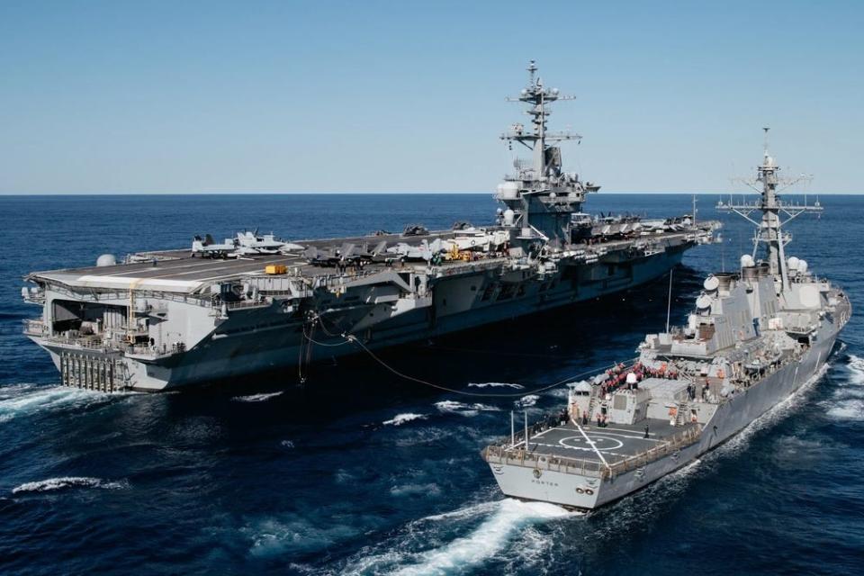 Arleigh-burke class guided-missile destroyer USS Porter conducts a replenishment-at-sea with Nimitz-class aircraft carrier USS George Washington