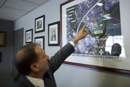 Commissioner of Philadelphia Prisons Louis Giorla points towards an aerial view of Curran-Fromhold Correctional Facility in Philadelphia, Pennsylvania, August 7, 2015. REUTERS/Mark Makela