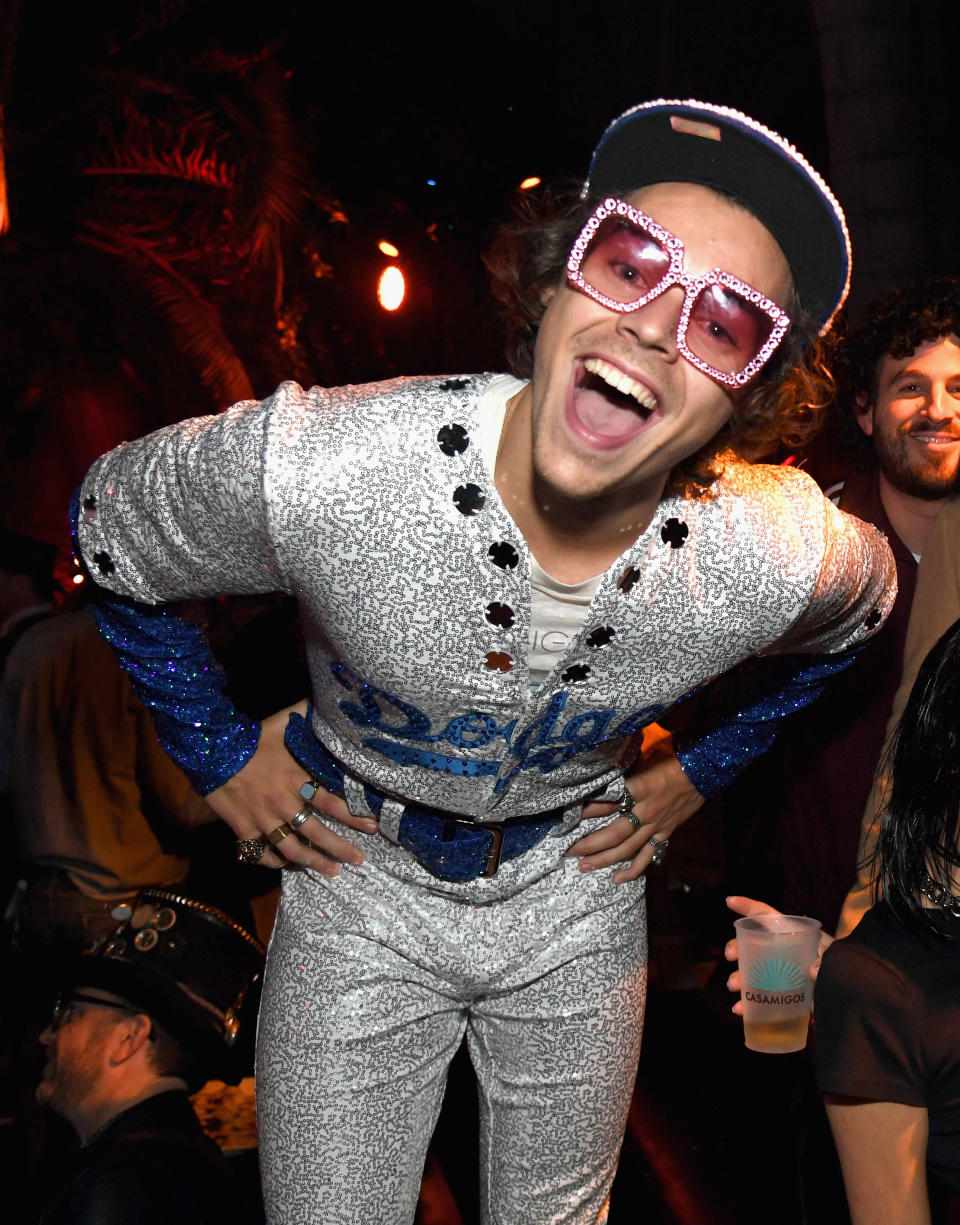 <p>Harry Styles dressed like close pal Elton John for the Casamigos Halloween party with a pair of the singer’s famous bejewelled sunnies to finish. <em>[Photo: Getty]</em> </p>