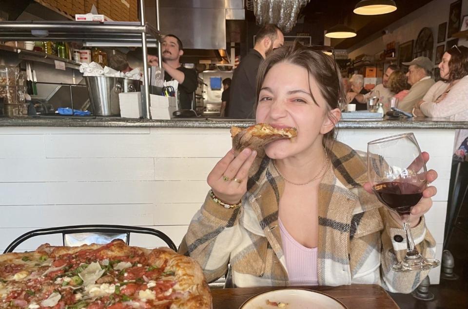 Caroline Hebert enjoying pizza and wine at Prima in New Smyrna Beach.