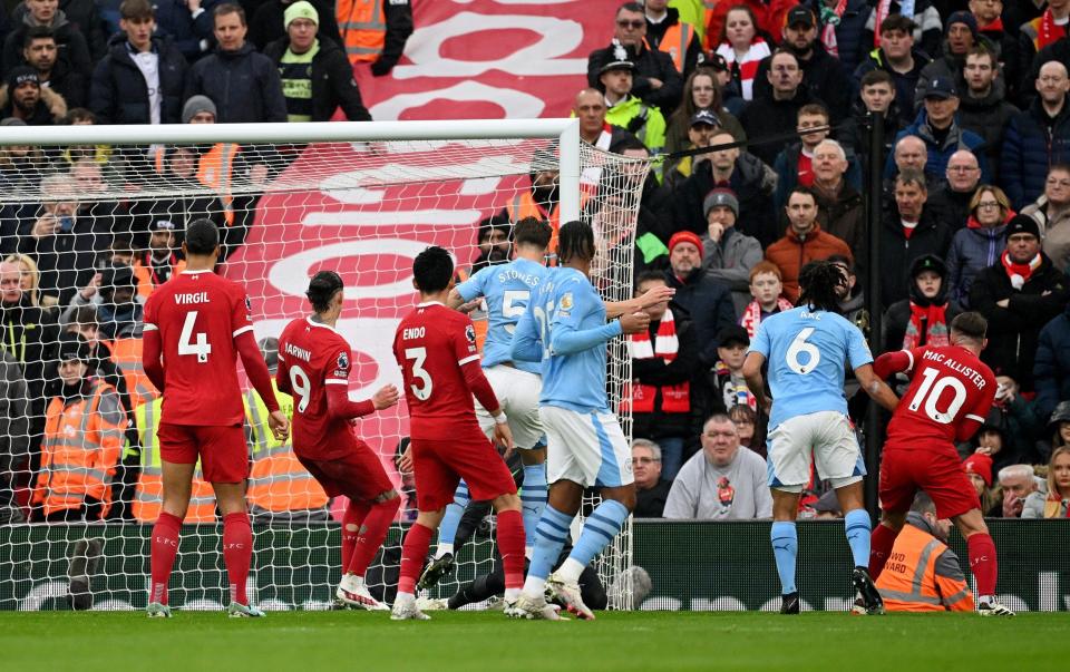 John Stones of Manchester City scores his team's first goal during the Premier League match between Liverpool FC and Manchester City
