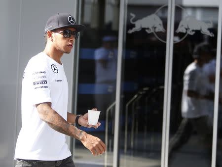 Mercedes Formula One driver Lewis Hamilton of Britain walks in the paddock at the Hungaroring circuit, near Budapest, July 25, 2014. REUTERS/Bernadett Szabo