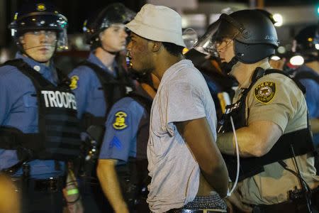 St Louis County police officers arrest an anti-police demonstrator in Ferguson, Missouri August 10, 2015. REUTERS/Lucas Jackson