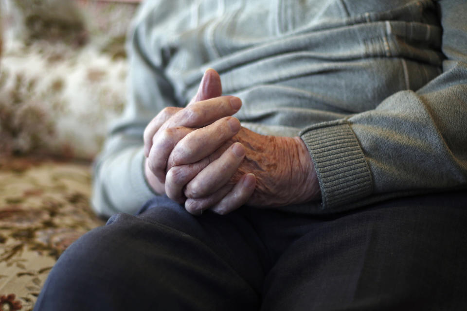 In this photo made Thursday, May 9, 2019, French World War II veteran Leon Gautier poses for a picture in his house, in Ouistreaham, Normandy. Of 177 in an elite French unit who landed in Normandy on June 6, 1944, just two dozen survived unscathed, Gautier among them. (AP Photo/Thibault Camus)