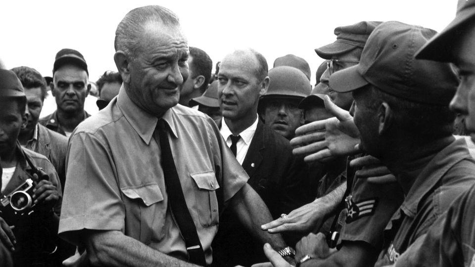 Johnson shakes the hands of soldiers as he visits American troops in Vietnam in 1966. - Interim Archives/Getty Images