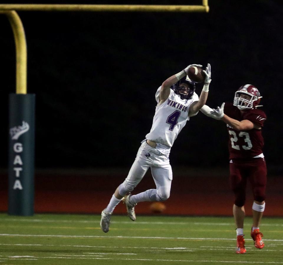 North Kitsap's Benen Lawler (4) intercepts a pass intended for W.F. West's Evan Stajduhar (23) during their game in Tumwater on Saturday, Nov. 26, 2022.