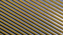 <p>Long lines of solar panels stripe the ground.</p>