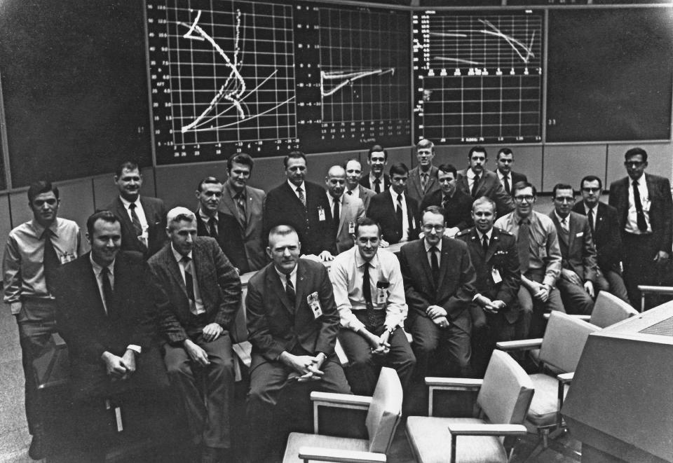 This July 1969 photo from NASA shows Flight Activities Officer Spencer Gardner, first row fourth from right, with members of the Apollo 11 White Team, handling descent and landing, in the Mission Operation Control Room in Houston, shortly after the mission. Barely 26, Gardner was one of the youngest flight controllers on duty when the Eagle settled onto the Sea of Tranquility with Neil Armstrong and Buzz Aldrin on July 20, 1969. (NASA via AP)