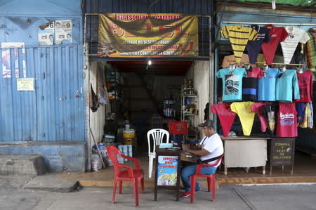 Luis Olarte, 38, a shopkeeper waits for clients at a small shop filled with subsidized goods smuggled over from Venezuela in the border town of Puerto Santander, Colombia September 8, 2015. REUTERS/Girish Gupta