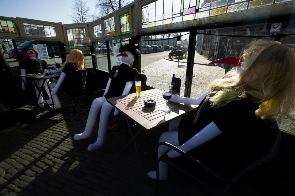 Real drinks were served on a terrace filled with inflatable dolls during a protest action at cafe De Ooievaar in Delfshaven, Rotterdam, Netherlands, Tuesday, March 2, 2021. Stores in one village opened briefly, cafe owners across the Netherlands were putting tables and chairs on their outdoor terraces and sex workers were planning a demonstration outside parliament in protests against the government's tough coronavirus lockdown. (AP Photo/Peter Dejong)