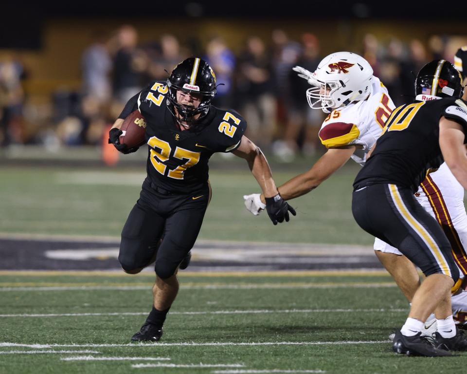 Southeast Polk's Harrison Gibson (27) avoids the tackle from Ankeny's Andrew Haase (95) at Southeast Polk High School in Pleasant Hill on Sept. 16.