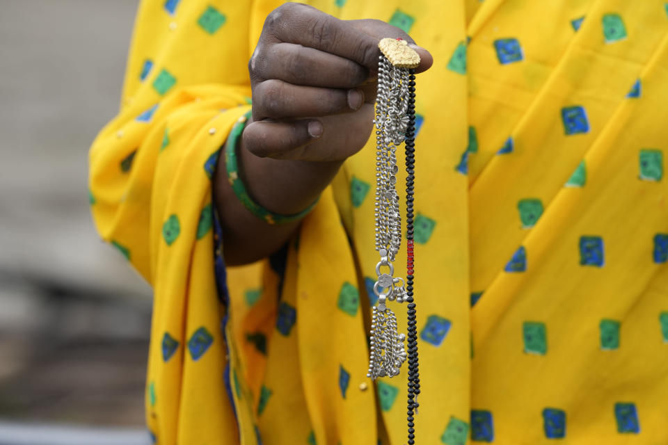 A neighbour displays the half-charred anklet that Khushboo Bind was wearing when a lightning struck and killed her in a paddy field on July 25, at Piparaon village on the outskirts of Prayagraj, in the northern Indian state of Uttar Pradesh, Thursday, July 28, 2022. Seven people, mostly farmers, were killed by lightning in a village in India's northern Uttar Pradesh state, police said Thursday, bringing the death toll by lightning to 49 people in the state this week. (AP Photo/Rajesh Kumar Singh)