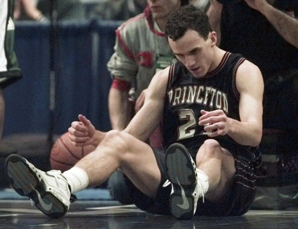 FILE - Princeton's Mitch Henderson reacts on the floor during their 63-56 loss to Michigan State University in a second-round college basketball game in NCAA Tournament in Hartford, Conn., Saturday, March 14, 1998. Princeton’s upset of Arizona conjured up memories of what the Tigers achieved in the 1990s when current coach Mitch Henderson was a player. Instead of going down memory lane, Henderson wants to make sure the focus is on what this group of players is accomplishing. (AP Photo/Elise Amendola, File)