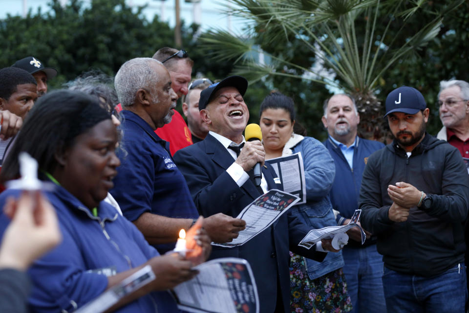 New Orleans music legend Deacon John Moore sings "Amazing Grace" during a candlelight vigil outside city hall for deceased and injured workers from the Hard Rock Hotel construction collapse Sat., Oct. 12, in New Orleans, on Thursday, Oct. 17, 2019. The vigil was organized by various area labor groups. (AP Photo/Gerald Herbert)