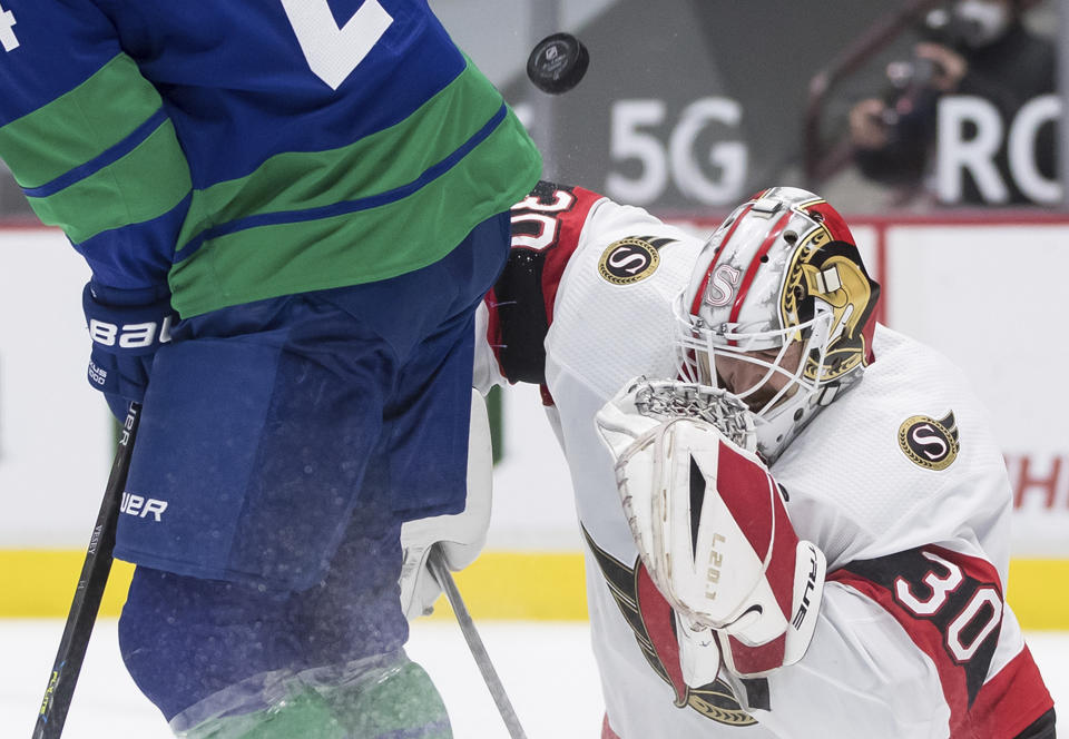 Ottawa Senators goalie Matt Murray (30) makes a blocker save while being screened by Vancouver Canucks' Jimmy Vesey during the second period of an NHL hockey game in Vancouver, British Columbia, Thursday, April 22, 2021. (Darryl Dyck/The Canadian Press via AP)