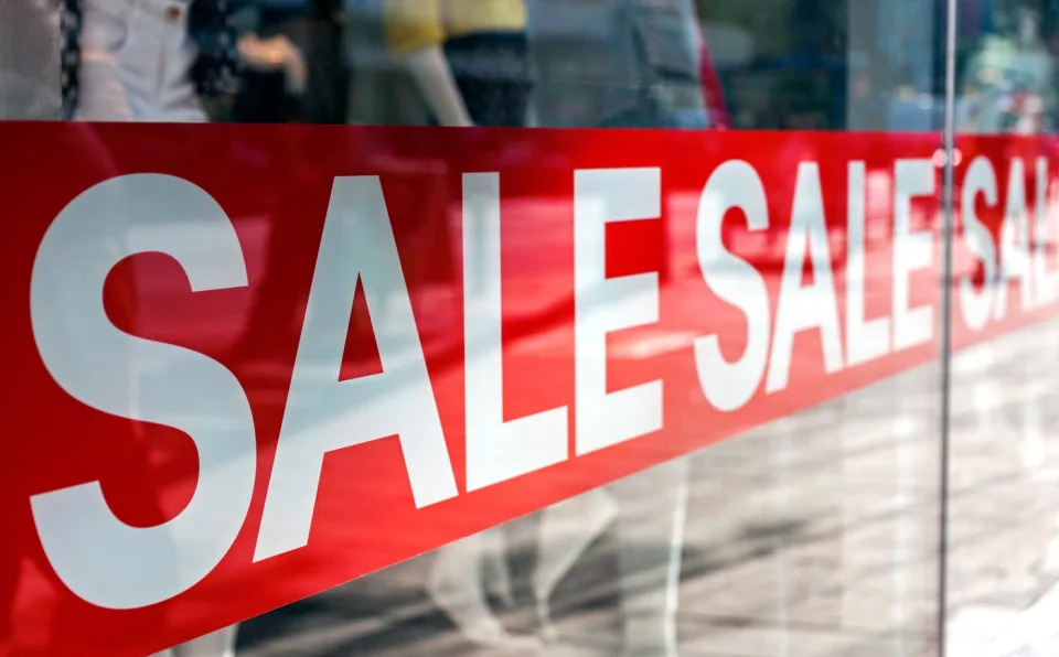 A Sale banner across the front of a store.